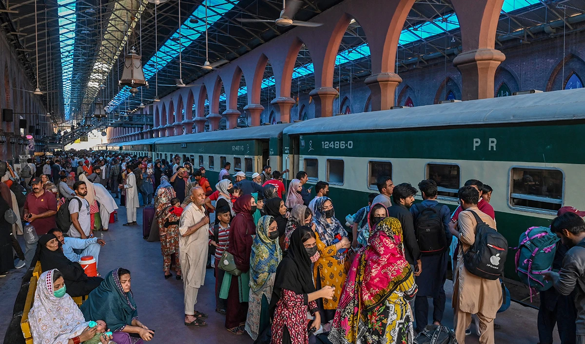 People wait to board a train at a railway station in Lahore on June 15, 2024, as they travel back home ahead of Eid al-Adha, the feast of the sacrifice marking the end of the Hajj pilgrimage to Mecca. (AFP/File)