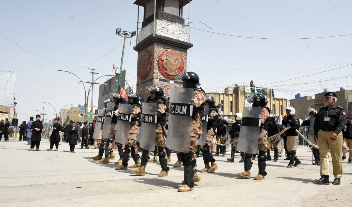 Security personnel stand guard during a procession of Shiite Muslims on the tenth day of Ashura in the Islamic month of Muharram, in Quetta on July 29, 2023. (AFP/File)_