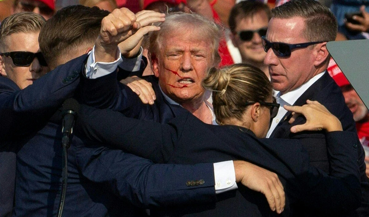 Republican candidate Donald Trump is seen with blood on his face surrounded by secret service agents as he is taken off the stage at a campaign event at Butler Farm Show Inc. in Butler, Pennsylvania, July 13, 2024. (AFP)