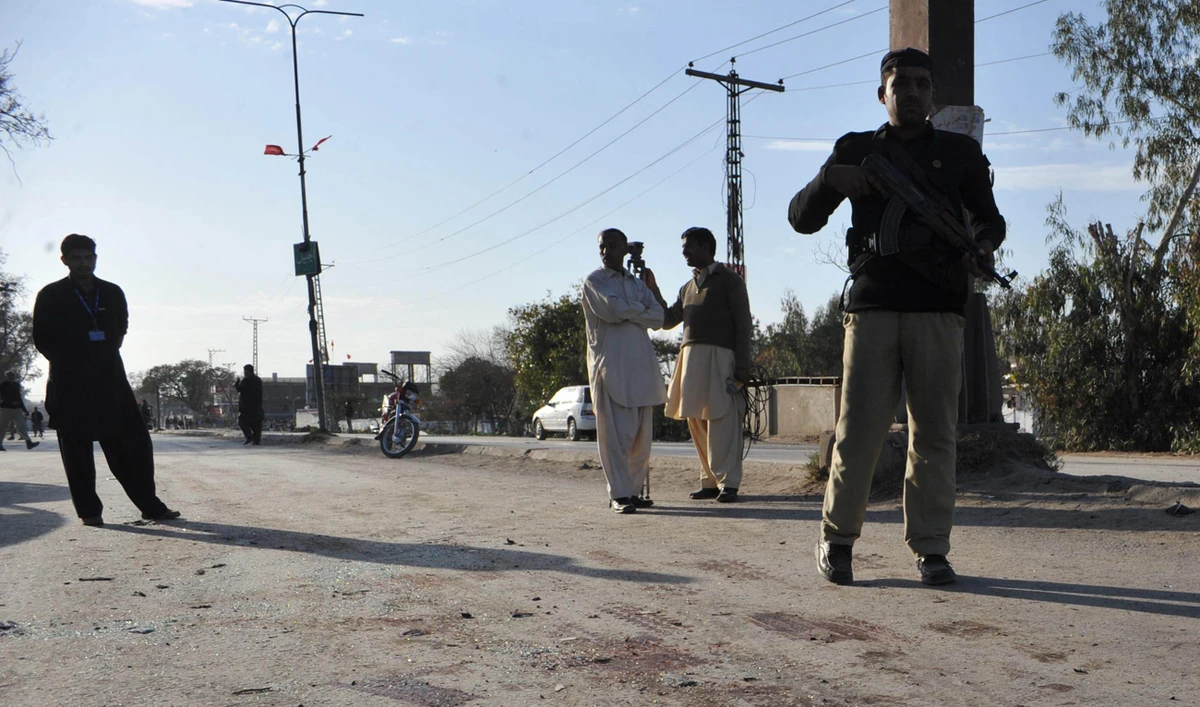 In this file photograph, taken on February 27, 2012, a Pakistani policeman stands guard at the site of a bomb blast in Nowshera. (AFP/File)