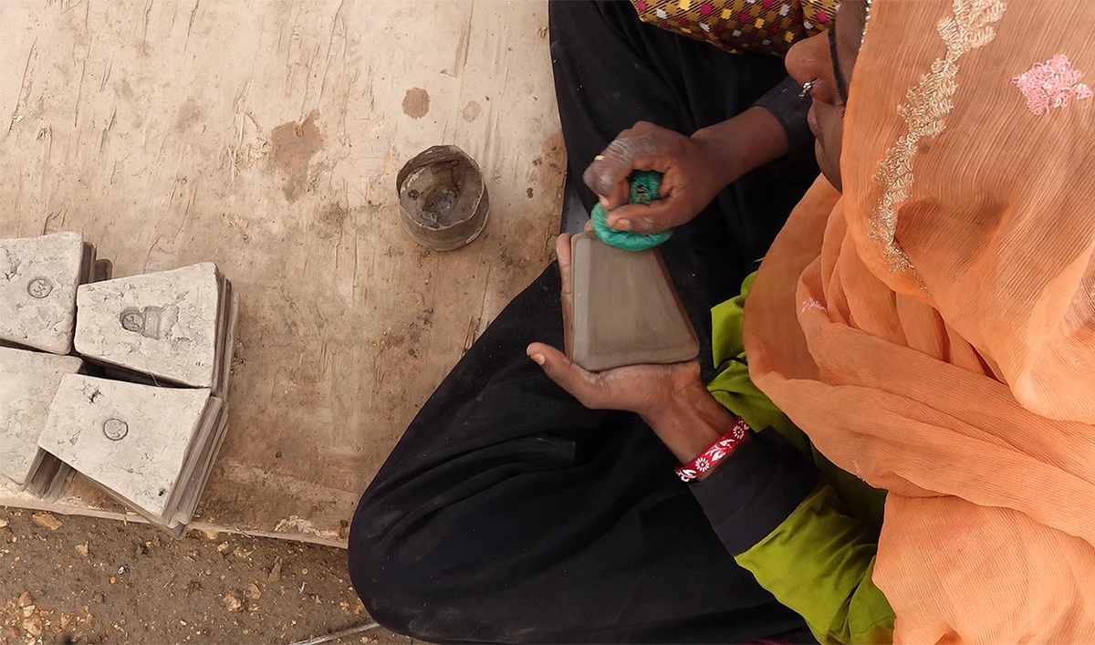 A woman is seen making tiles in Makli in Pakistan's southern Sindh province on July 20, 2024. (AN photo)