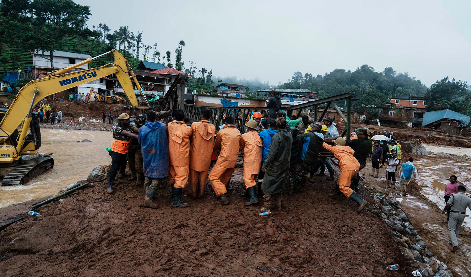 Indian army soldiers make a bailey bridge as rescuers search through mud and debris for a third day after landslides set off by torrential rains in Wayanad district, Kerala state, India, on August 1, 2024. (AP)