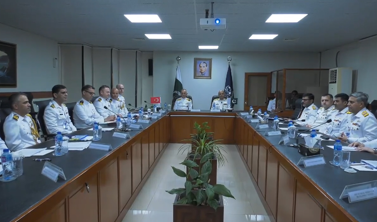In this handout photograph, taken and released by Director General Public Relations Pakistan Navy on August 3, 2024, Pakistan and Turkiye’s navy officials hold expert-level talks to discuss joint operations at Pakistan’s Naval Headquarters in Karachi. (Photo courtesy: Pakistan Navy)