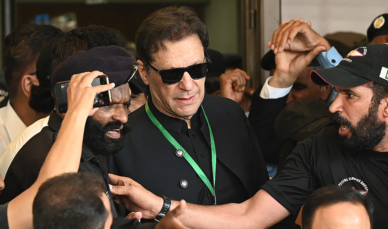 In this file photo, taken on July 24, 2023, Pakistan’s former Prime Minister Imran Khan (C) leaves after appearing in the Supreme Court in Islamabad. (AFP/File)