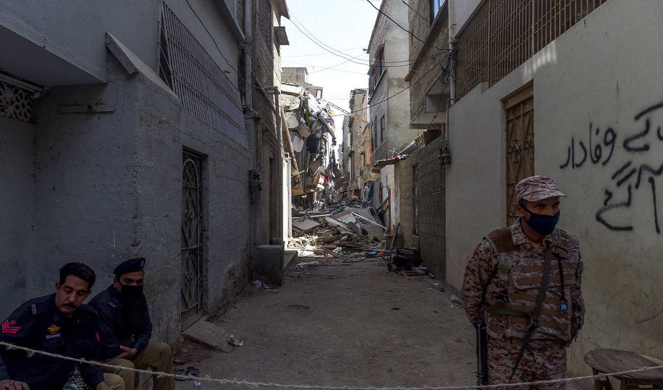Pakistani security officials cordon a street beside a collapsed residential building in Karachi on March 6, 2020. (AFP/File)