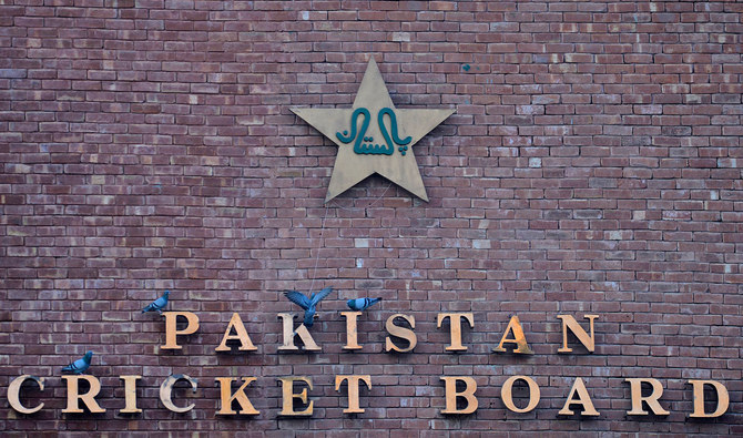 This picture taken on September 7, 2017 shows pigeons resting on a sign for the Pakistan Cricket Board at the Gaddafi Stadium in Lahore. (AFP/File)