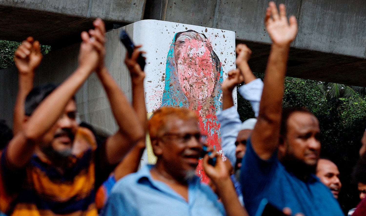 A mural of Prime Minister Sheikh Hasina is seen vandalised by protesters as people celebrate her resignation in Dhaka, Bangladesh, on August 5, 2024. (REUTERS/File)