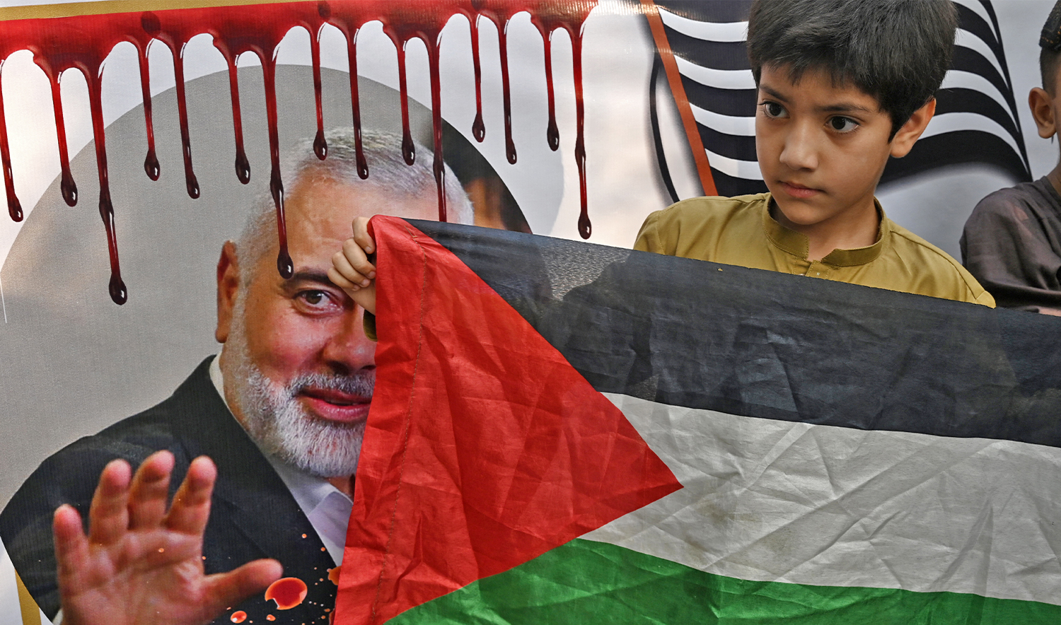A child holding a Palestinian national flag takes part in a protest against the assassination of Hamas chief Ismail Haniyeh in an air strike in Tehran, in Lahore on August 2, 2024. (AFP/File)