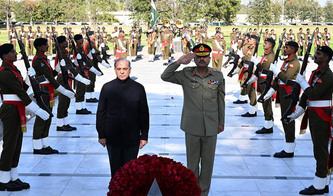In this handout picture, taken and released by Inter Services Public Relations (ISPR) on March 15, 2024, shows Pakistan’s Prime Minister Shehbaz Sharif (left) and Army Chief General Asim Munir salute after laying a wreath at Yadgar-e-Shuhada in Rawalpindi. (ISPR/File)