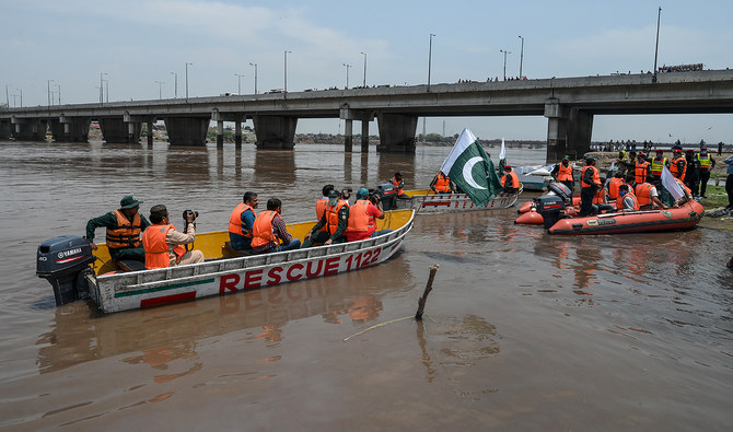 In this file phhoto, taken on June 4, 2020, rescue workers take part in a flood exercise in the Ravi river in Lahore. (AFP/File)