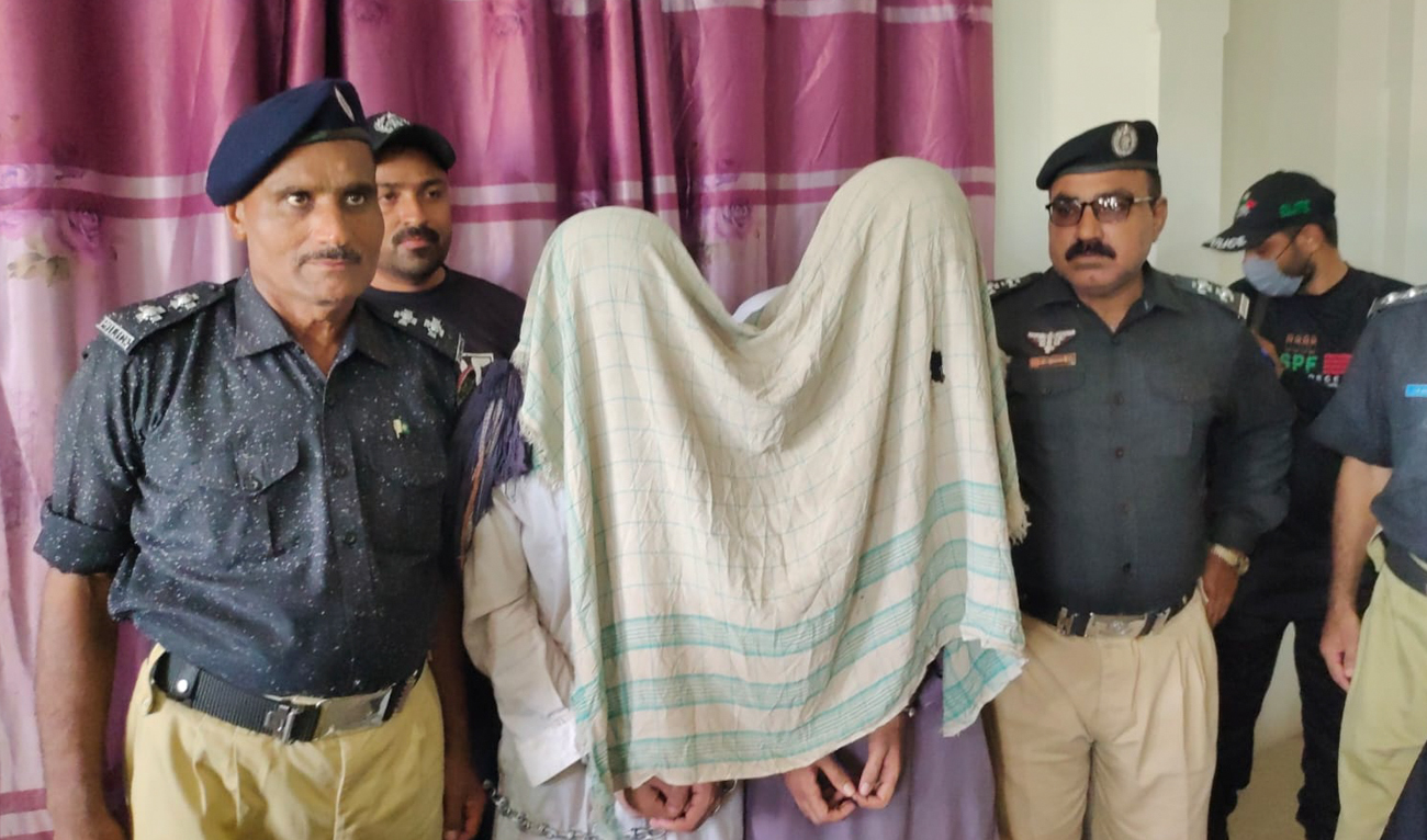 In this handout photograph, taken and released by the Counterterrorism Department, Pakistani police officers present two suspects arrested on terror charges, at a police station in Larkana, Sindh on August 10, 2024. (Photo courtesy: CTD)