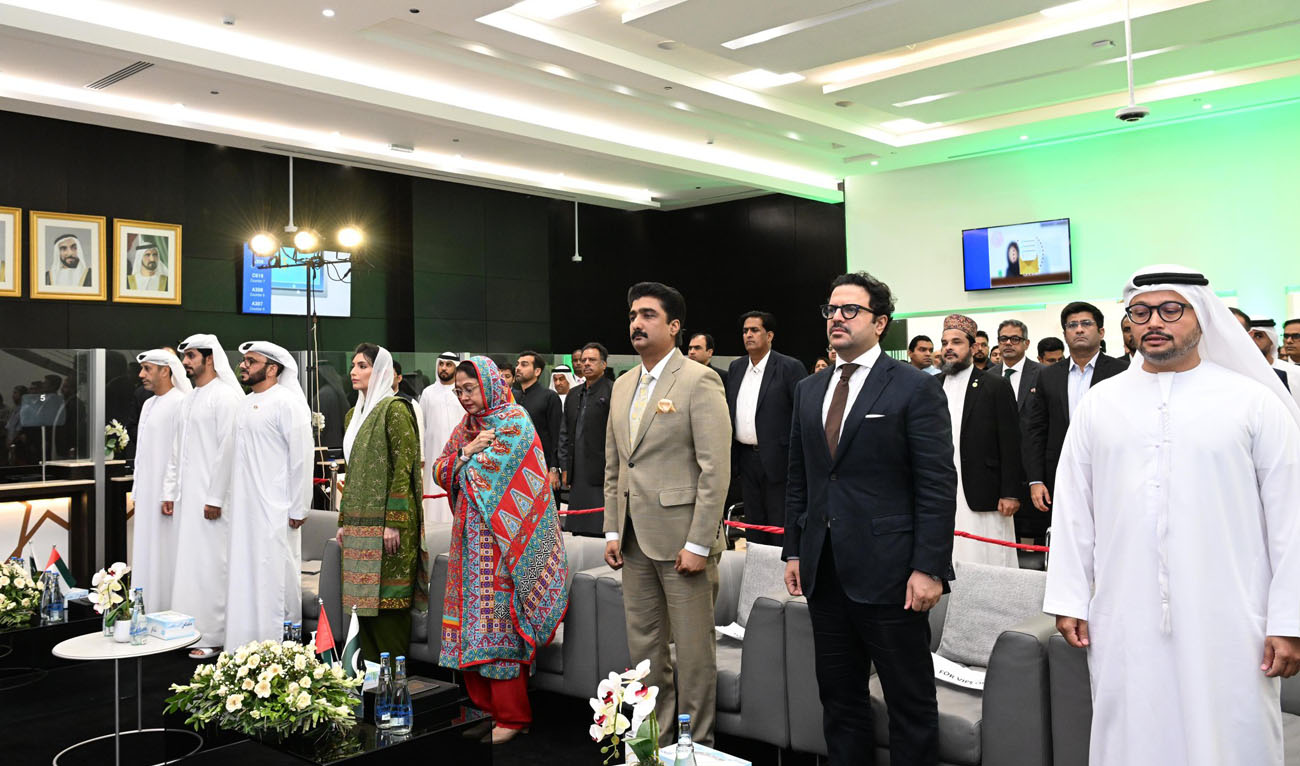 In this handout photograph, taken and released by Pakistan Peoples Party, PPP lawmaker and Pakistan’s First Lady Aseefa Bhutto Zardari (4R) gestures with Bakheet Ateeq Al-Remeithi (3R), UAE Consul General Karachi, during an Independence Day ceremony at the UAE Consulate in Karachi on August 13, 2024. (Photo courtesy: X/@PPPDigital_)