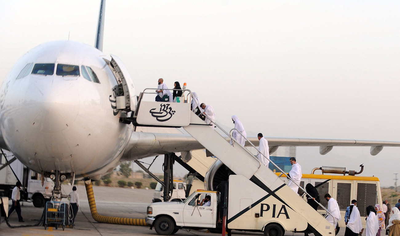 Pakistani Muslims board a Pakistan International Airlines (PIA) aircraft to Mecca in Saudi Arabia, for the annual Hajj pilgrimage from Quetta International airport in Quetta on September 30, 2011. (AFP/File)