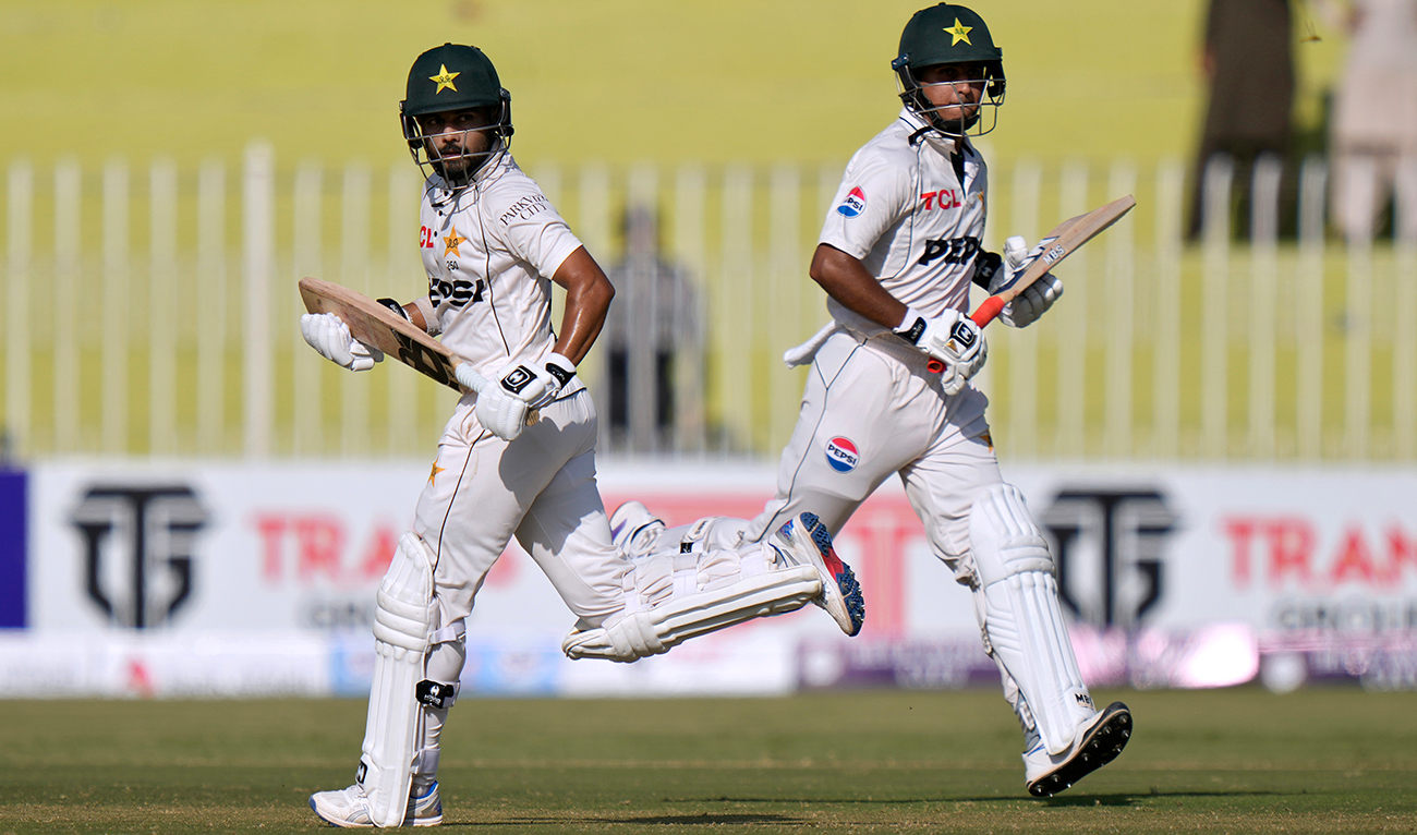 Pakistan's Saud Shakeel, left, and Saim Ayub run between the wicket during the first day of first cricket test match between Pakistan and Bangladesh, in Rawalpindi, Pakistan, Wednesday, Aug. 21, 2024. (AFP/File)