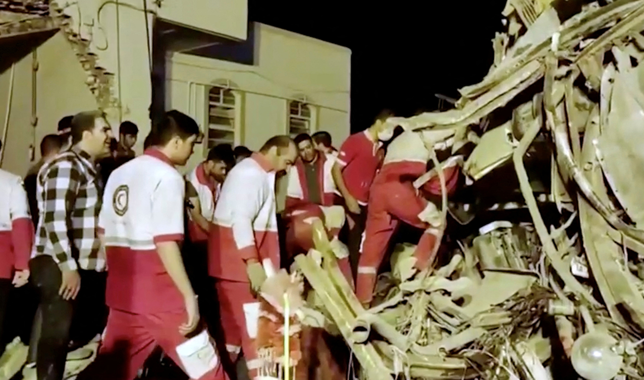 Rescuers work at the scene of a bus accident at Yazd province, Iran, in this still image taken from a video, August 21, 2024. (Reuters)