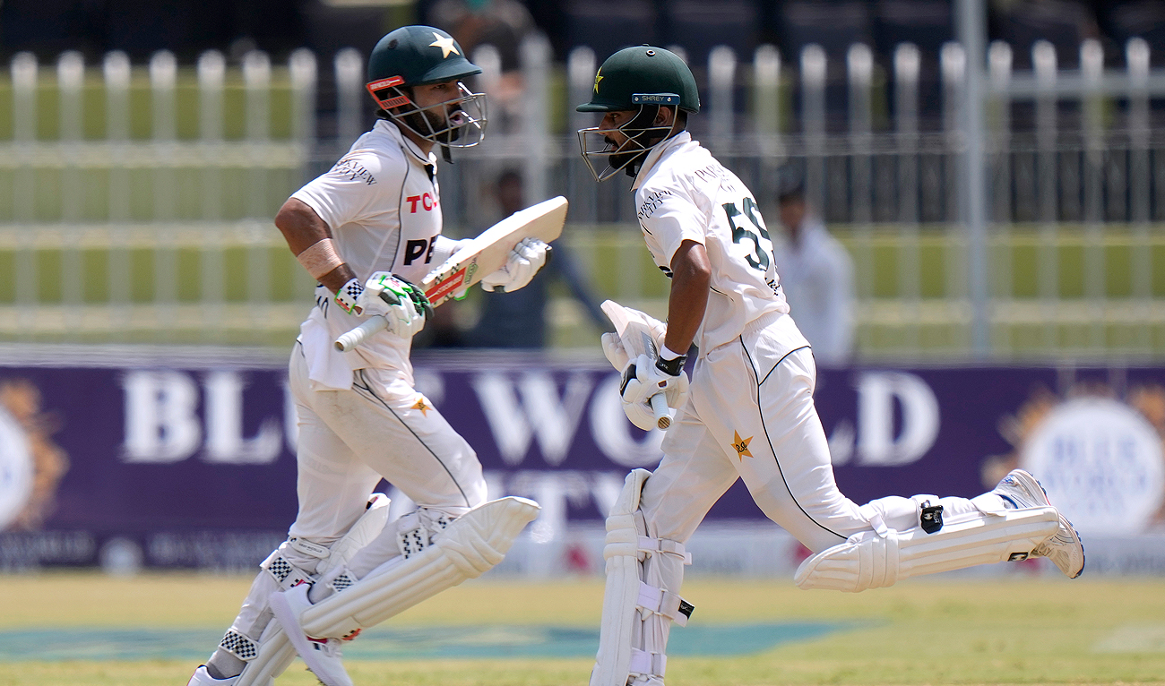 Pakistan’s Mohammad Rizwan, left, and Saud Shakeel run between the wickets during the second day of first cricket test match between Pakistan and Bangladesh, in Rawalpindi, Pakistan, Thursday, Aug. 22, 2024. (AP)