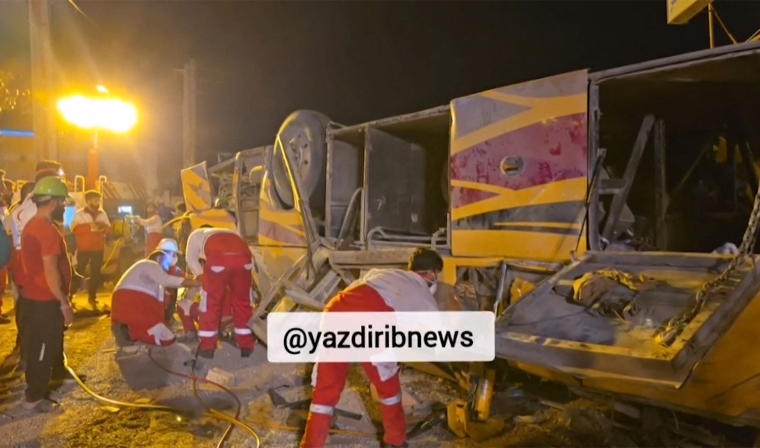 An image grab from footage obtained from Iranian State TV IRIB on August 21, 2024, shows Iranian first responders at the site of a bus crash in Iran's central Yazd province. (AFP/HO/IRIB NEWS)
