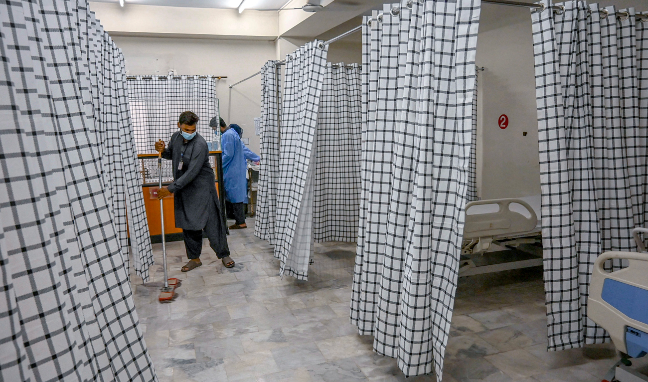 A worker cleans the floor of an isolation ward prepared for mpox patients at the Police and Services hospital in Peshawar on August 20, 2024. (AFP)