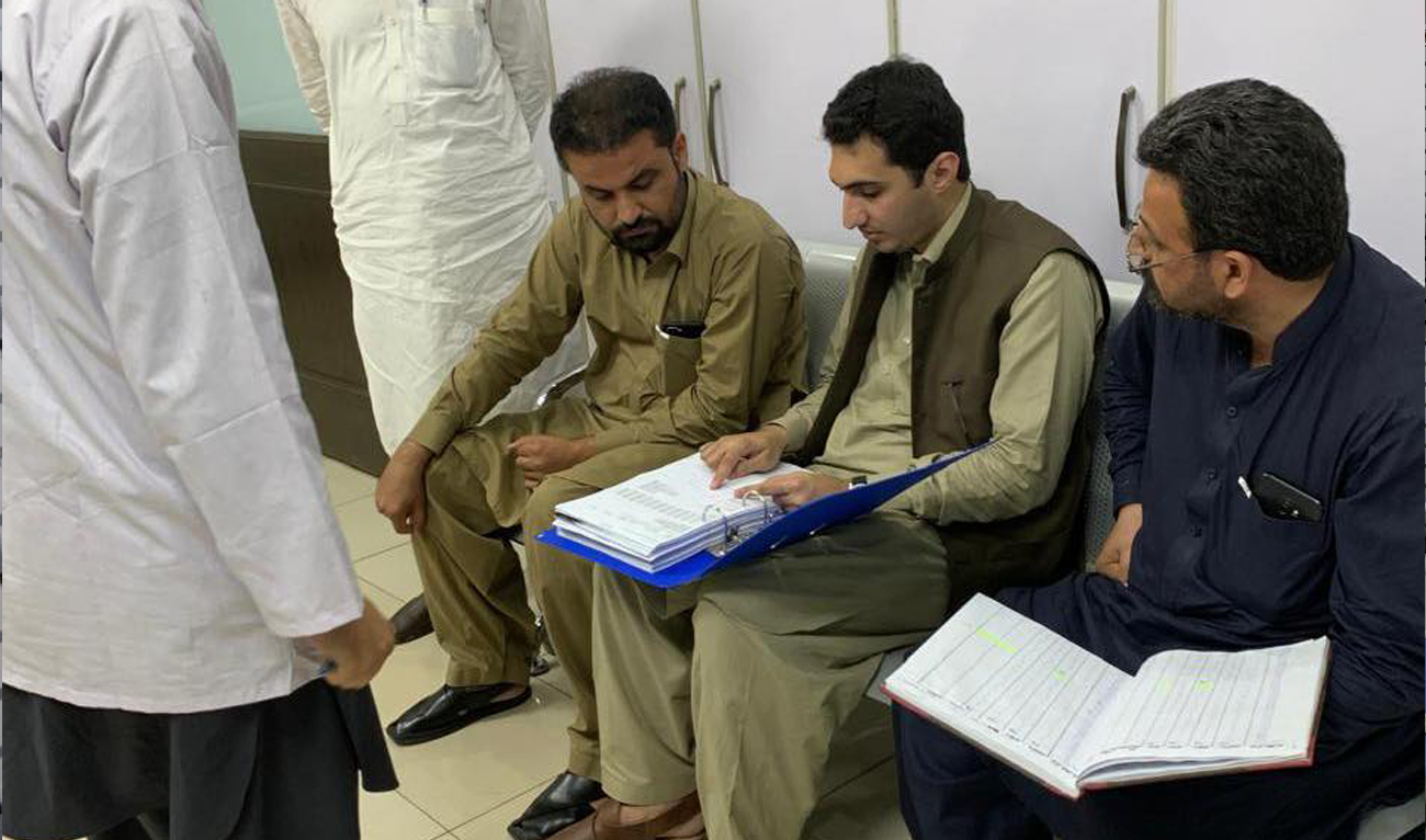 Officials from the Office of Deputy Commissioner Peshawar seal medical lab testing workers bound for Gulf states after inspection in Peshawar on August 23, 2024. (Photo courtesy: Deputy Commissioner Peshawar)