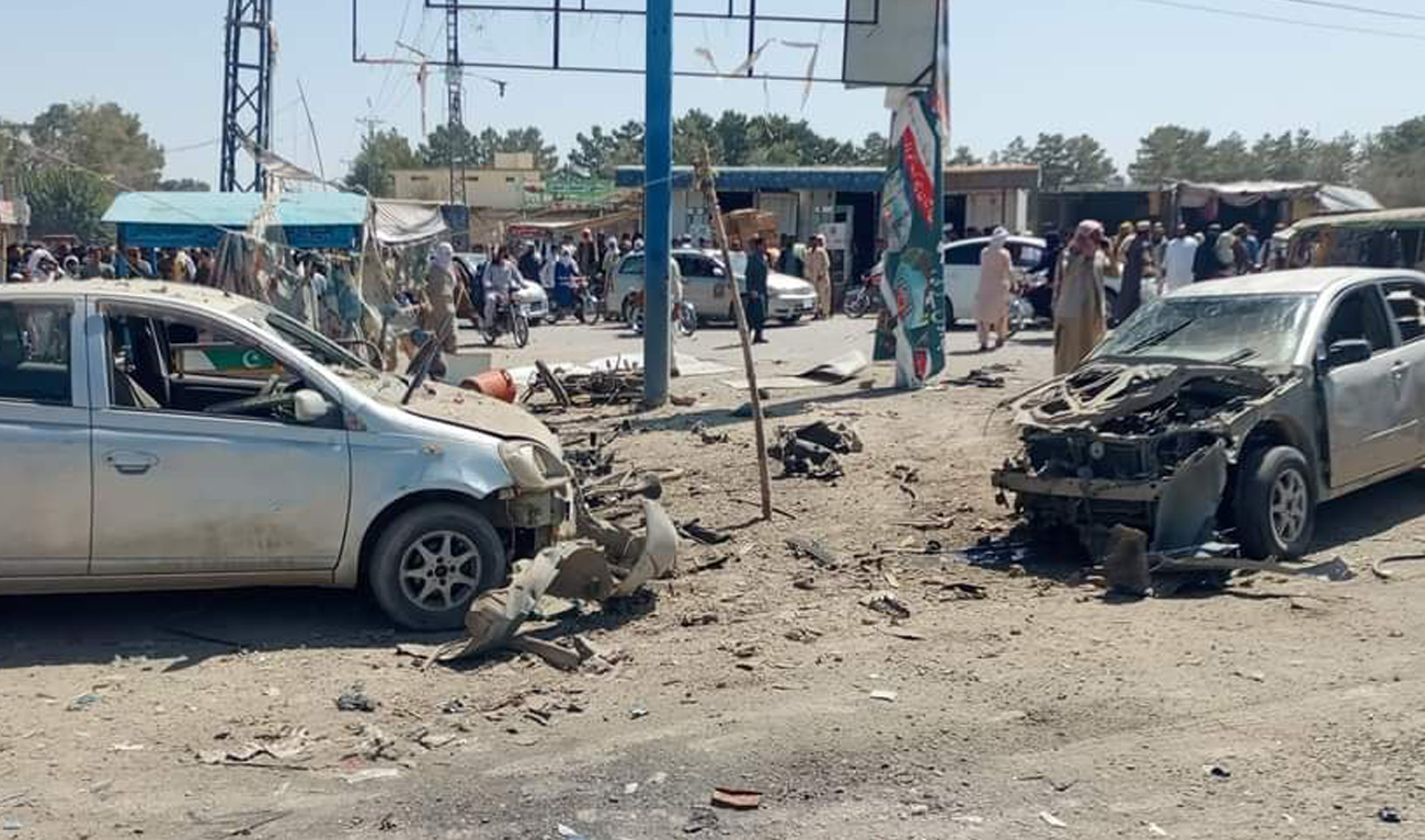 In this handout photo, taken and shared with Arab News by Balochistan Police, people gather at the site of a bomb blast near the Deputy Commissioner Complex in Pishin on August 24, 2024. (Handout/AN)