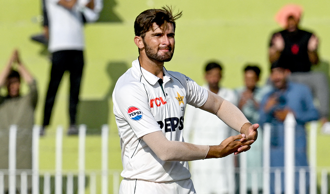 Pakistan’s Shaheen Shah Afridi celebrates his Test wicket, mimicking cradling a baby in his arms, during the fourth day of the first Test cricket match between Pakistan and Bangladesh at the Rawalpindi Cricket Stadium in Rawalpindi on August 24, 2024. (AFP)