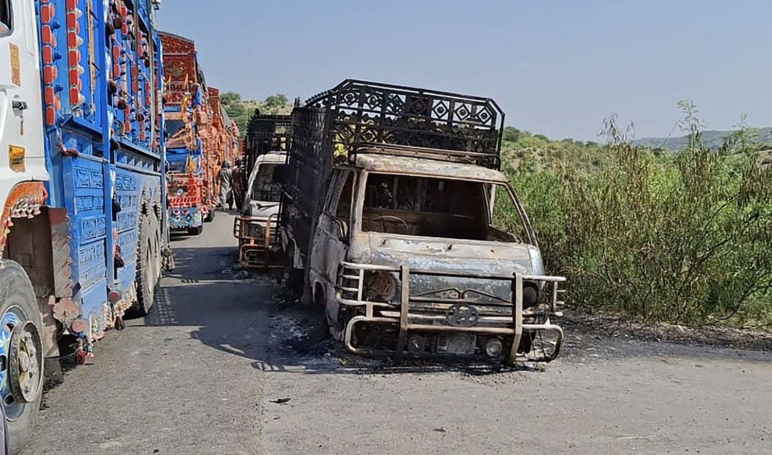 Charred vehicles are pictured at the shooting site on the national highway in Musakhail district, Balochistan province on August 26, 2024. (AFP)