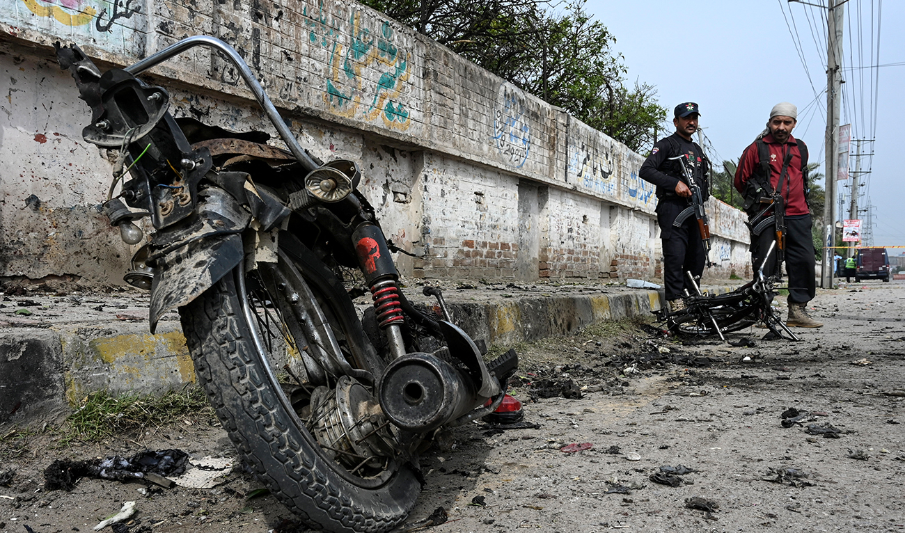 Security personnel examine the site of a blast in Peshawar district of the Khyber Pakhtunkhwa province on March 10, 2024. (AFP/File)
