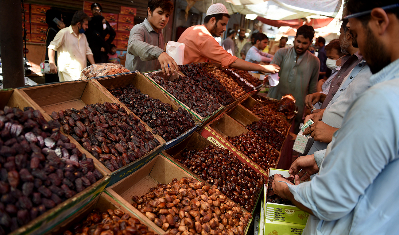 Residents buy dates at a market ahead of the Ramadan during a government-imposed nationwide lockdown as a preventive measure against the COVID-19 coronavirus, in Karachi on April 20, 2020. (AFP/File)