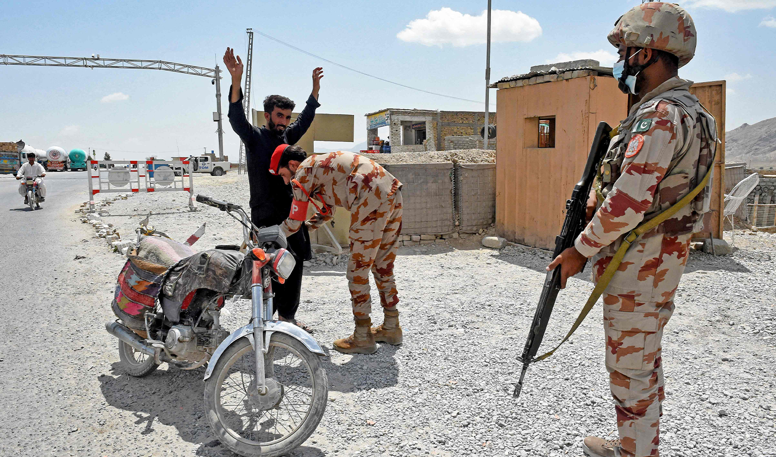 A Pakistani paramilitary ranger frisks a motorcyclist at a checkpoint a day after attacks by separatist militants on the outskirts of Quetta on August 27, 2024. (AFP)