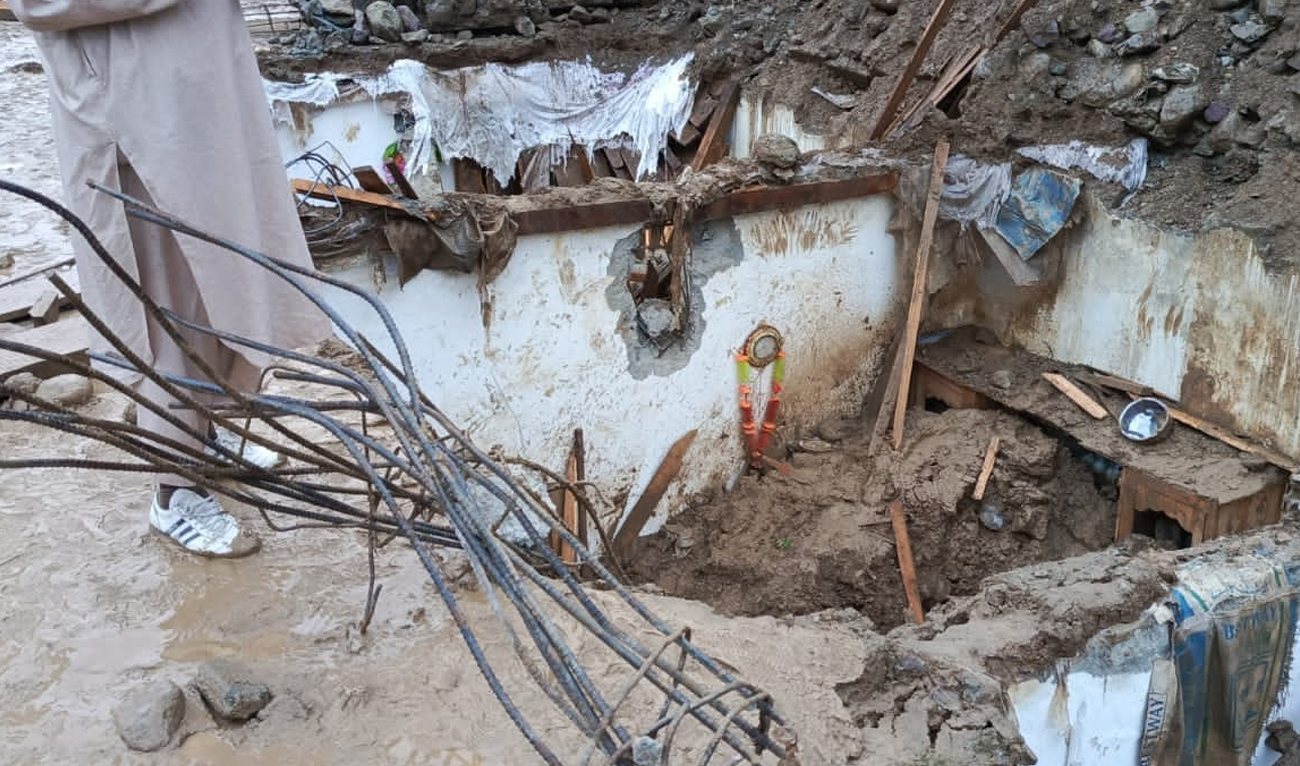 This handout photograph taken and released by Pakistan’s Khyber Pakhtunkhwa Emergency Service (Rescue 1122) shows aftermath of mudslide that damaged a house completely, killing 12 people in Upper Dir, Khyber Pakhtunkhwa. (Photo courtesy: Rescue 1122)