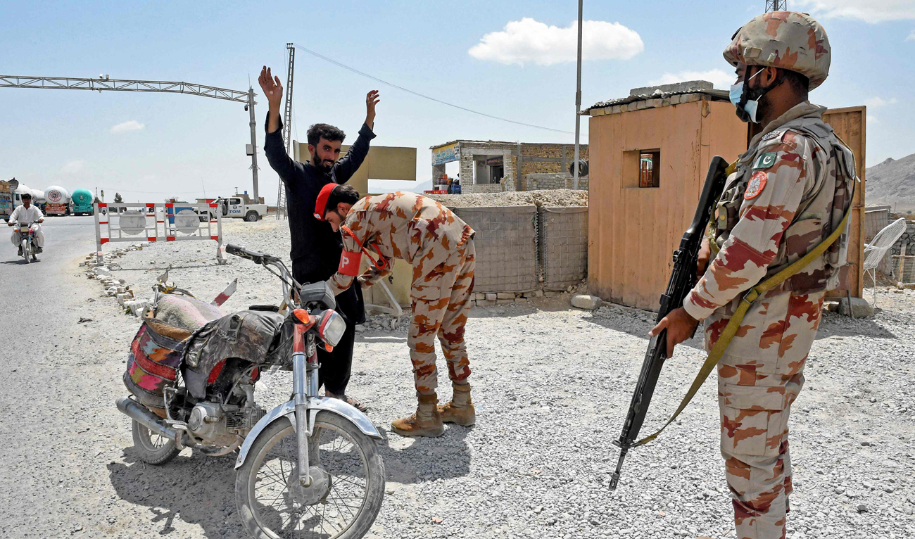 A Pakistani paramilitary ranger frisks a motorcyclist at a checkpoint a day after attacks by separatist militants on the outskirts of Quetta on August 27, 2024. (AFP)