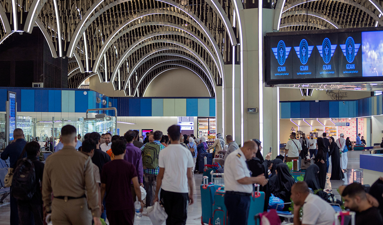 Travellers gather in the departure hall at the Baghdad International Airport on August 17, 2024. (AFP/File)