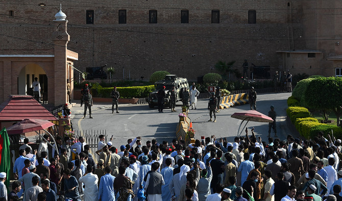 In this file photograph, taken on May 9, 2023, Pakistan Tehreek-e-Insaf party activists and supporters of former Pakistan’s Prime Minister Imran gather outside headquarters of the frontier corps during a protest against the arrest of their leader, in Peshawar. (AFP/File)