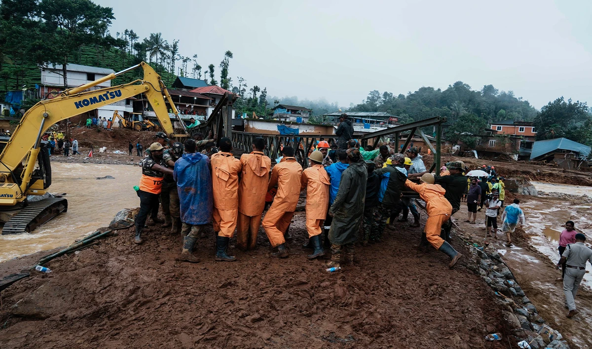 Indian army soldiers make a bailey bridge as rescuers search through mud and debris for a third day after landslides set off by torrential rains in Wayanad district, Kerala state, India, on August 1, 2024. (AP)