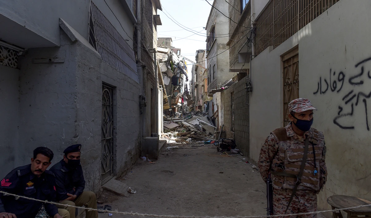 Pakistani security officials cordon a street beside a collapsed residential building in Karachi on March 6, 2020. (AFP/File)