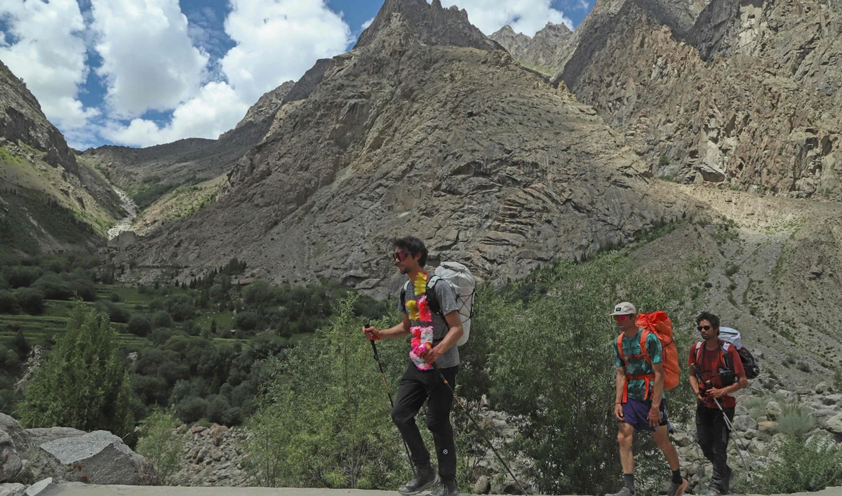 In this photograph taken on August 3, 2024, French climber Benjamin Vedrines (L) returns at Hushe village after he summited Pakistan’s K2 the world’s second-highest mountain in Pakistan’s Gilgit-Baltistan region. (AFP)