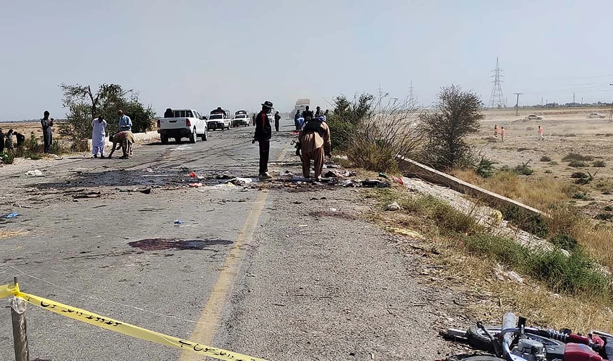 Security officials examine the site after a suicide attack on a police truck near Dhadar, the main town of Kachhi district, about 120 kms southeast of Quetta in Balochistan province on March 6, 2023. (AFP/File)