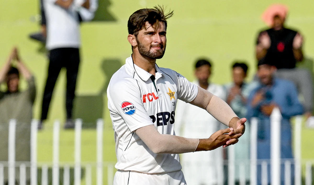 Pakistan’s Shaheen Shah Afridi celebrates his Test wicket, mimicking cradling a baby in his arms, during the fourth day of the first Test cricket match between Pakistan and Bangladesh at the Rawalpindi Cricket Stadium in Rawalpindi on August 24, 2024. (AFP)
