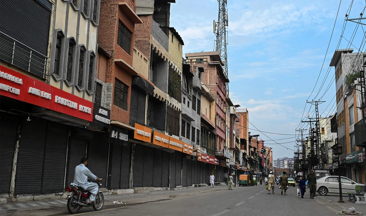 Commuters make their way through a partially deserted street during a nationwide strike called by trade organisations against the high electricity bills, excessive taxes and the absence of business-friendly policies, at Peshawar on August 28, 2024. (AFP)