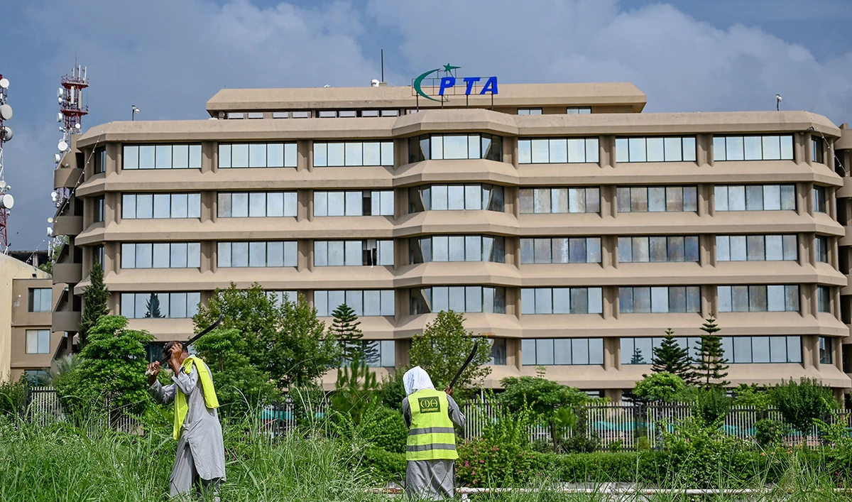 People work near the Pakistan Telecommunication Authority (PTA) headquarters building in Islamabad on August 16, 2024. (AFP/File)