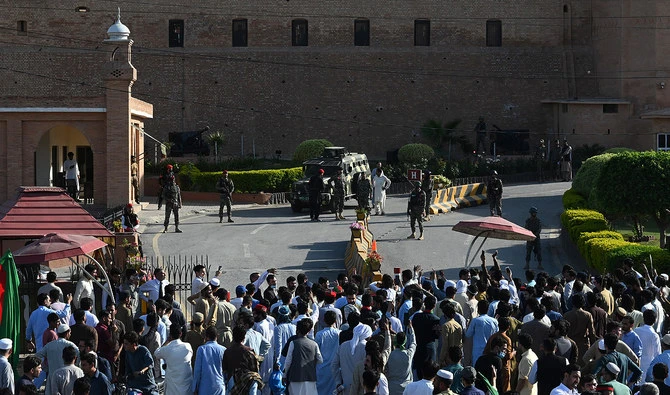 In this file photograph, taken on May 9, 2023, Pakistan Tehreek-e-Insaf party activists and supporters of former Pakistan’s Prime Minister Imran gather outside headquarters of the frontier corps during a protest against the arrest of their leader, in Peshawar. (AFP/File)