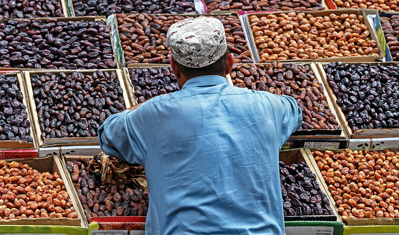 A vendor arranges dates on his cart at a market in Rawalpindi on June 1, 2023. (AFP/File)