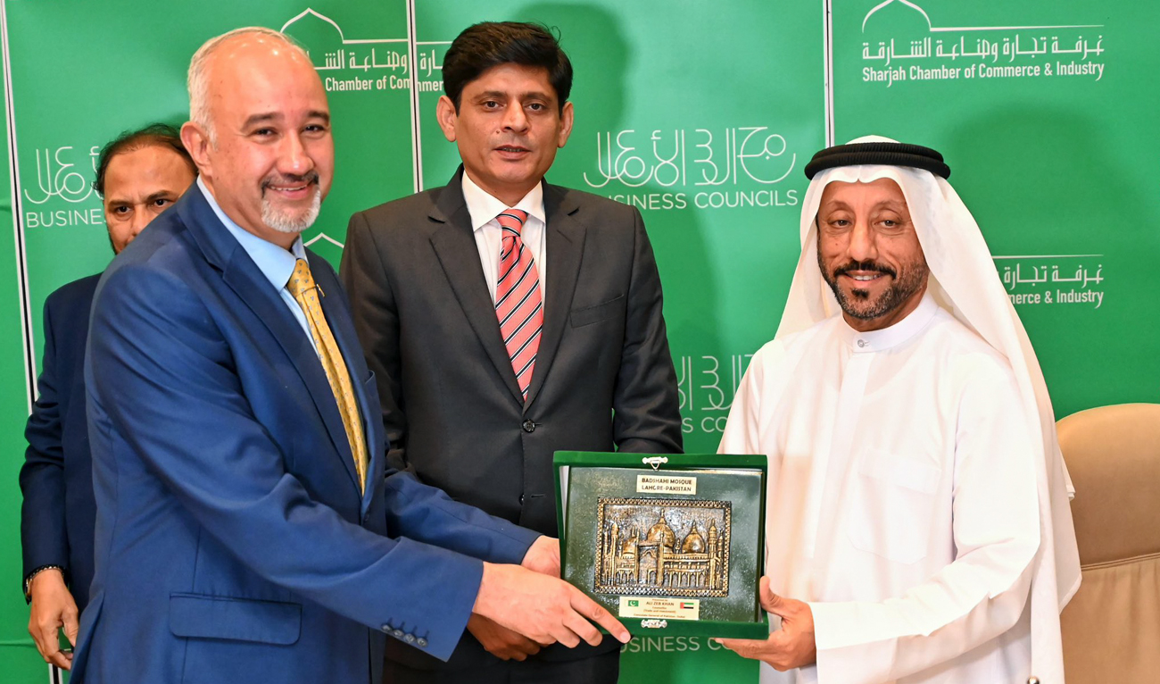 In this handout photograph, taken and released by Pakistan Embassy in UAE on September 3, 2024, Abdallah Sultan Al Owais (right), Chairman of the Sharjah Chamber of Commerce, and Industry, presents souvenir to Ambassador Faisal Niaz Tirmizi during an inauguration ceremony of Pakistan Business Council in Sharjah. (Photo courtesy: X/ @PakinUAE_)
