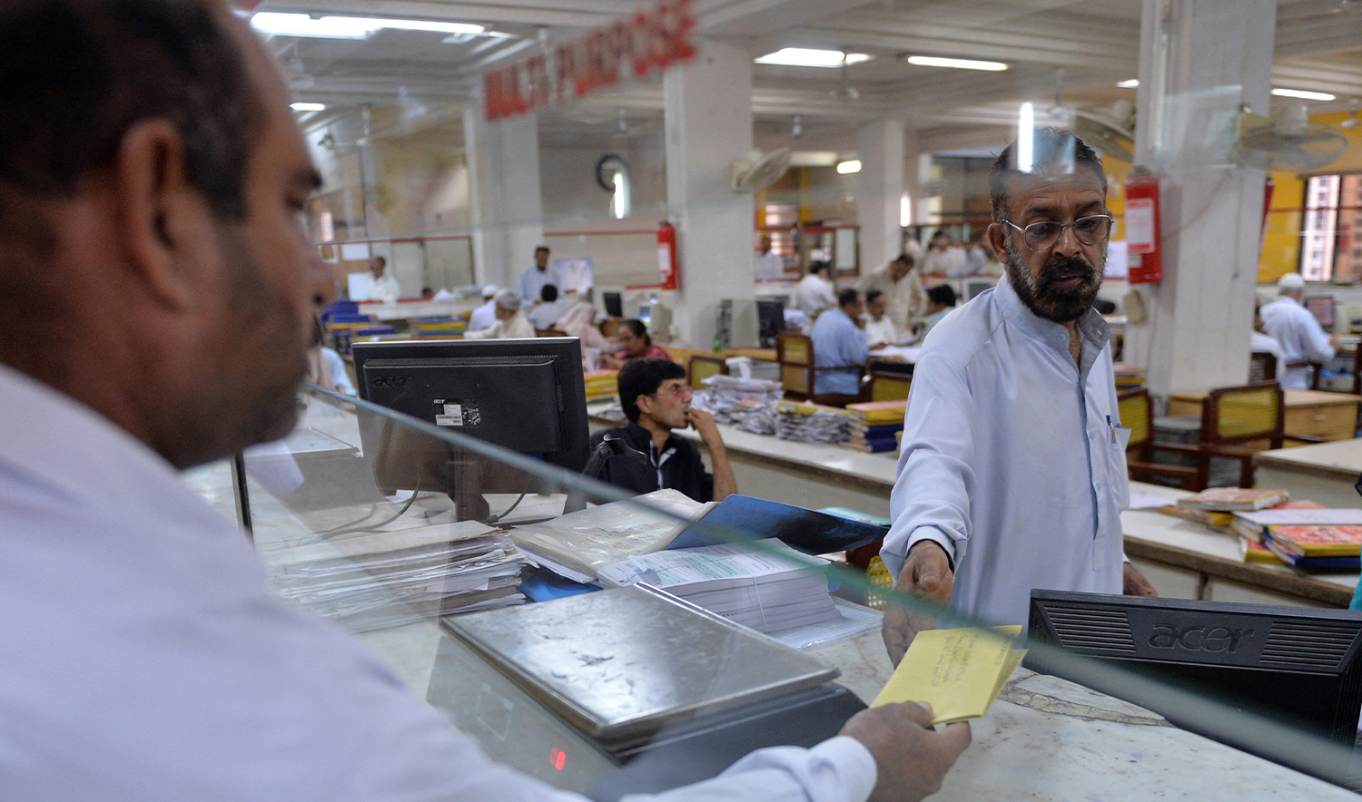 A Pakistani Post office employee takes mail from a customer in Islamabad on September 12, 2013. (AFP/File)
