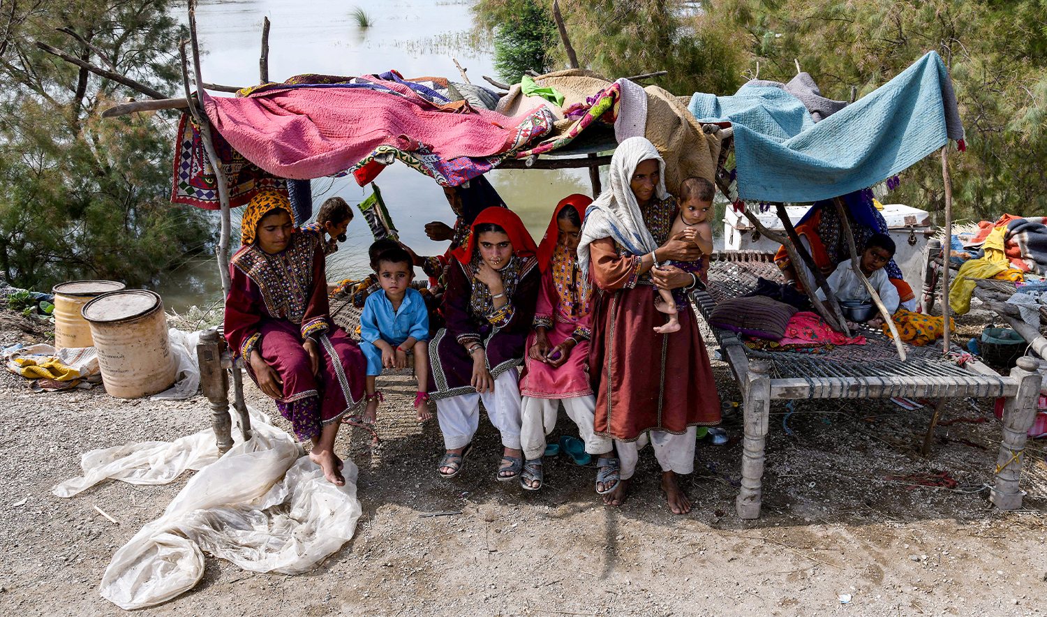 A flood affected family rests in a makeshift shelter following heavy monsoon rains on the outskirts of Larkana, Sindh province on August 31, 2024. (AFP/File)