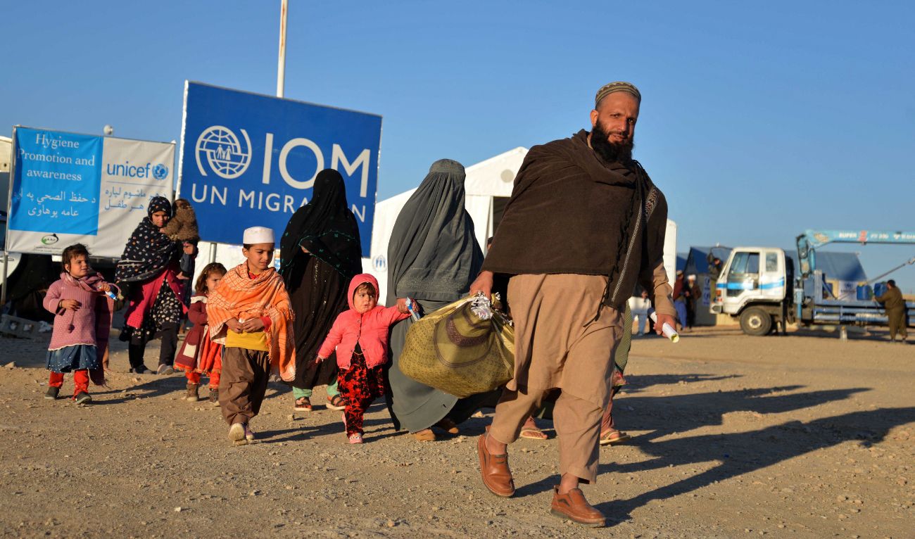 Afghan refugees walk at a registration centre, upon their arrival from Pakistan in Takhta Pul district of Kandahar province on December 18, 2023. (AFP/File)