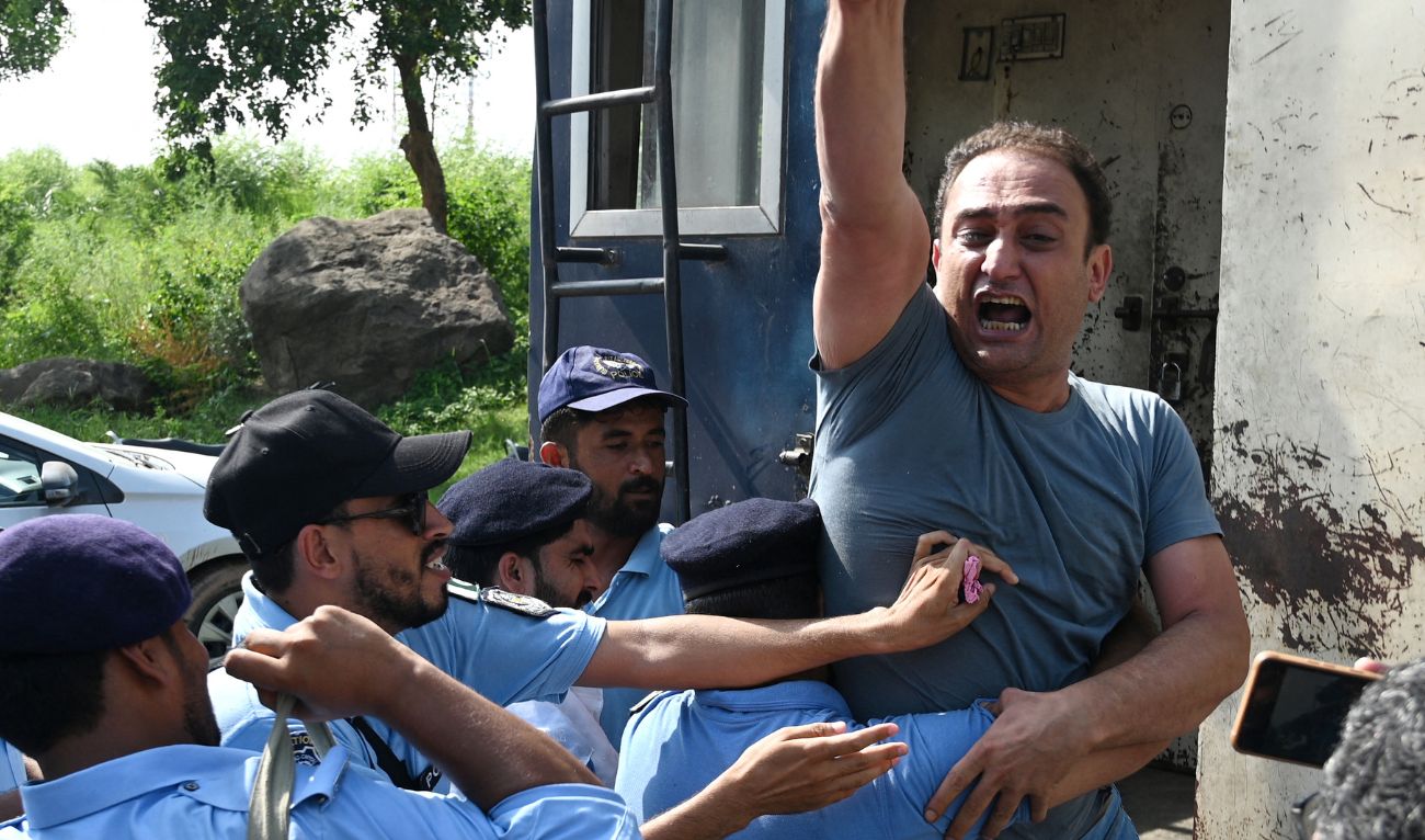 Policemen detain an activist of Pakistan Tehreek-e-Insaf (PTI) party during a protest outside the an anti-terrorism court in Islamabad on September 10, 2024. (AFP)