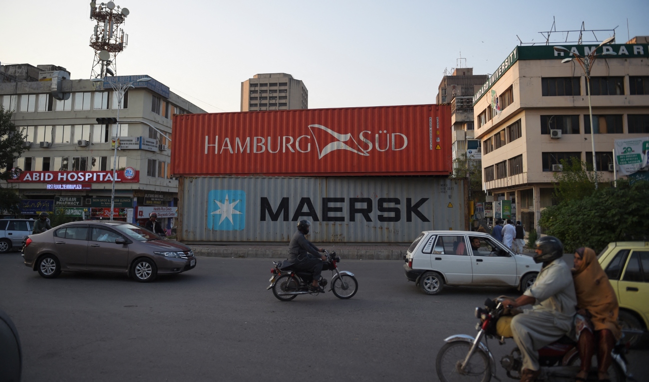 Commuters drive past containers placed on roadside in Islamabad on October 26, 2019. (AFP/File)