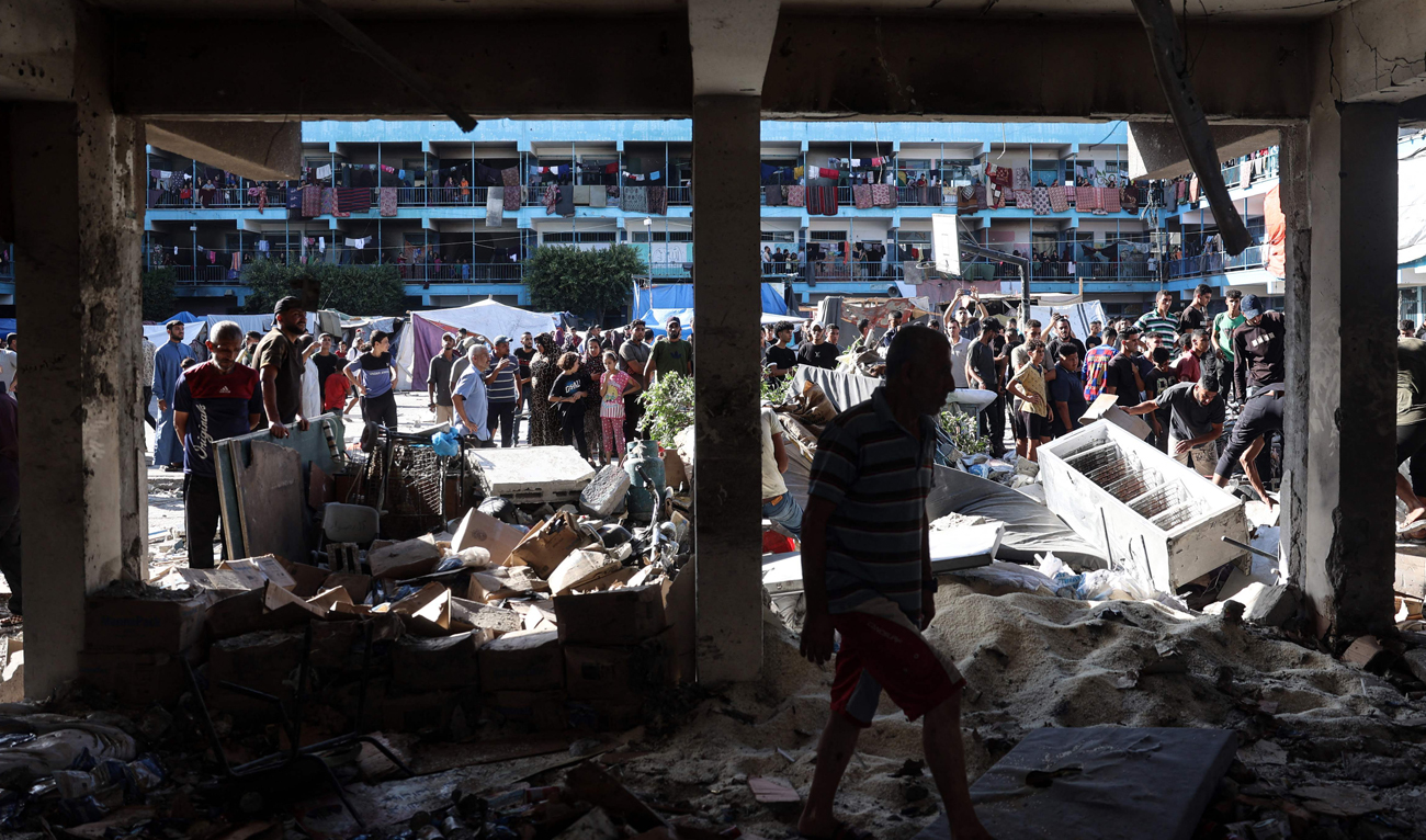 Palestinians check the grounds of a school after an Israeli air strike hit the site, in Nuseirat in the central Gaza Strip on September 11, 2024, amid the ongoing war in the Palestinian territory between Israel and Hamas. (AFP)