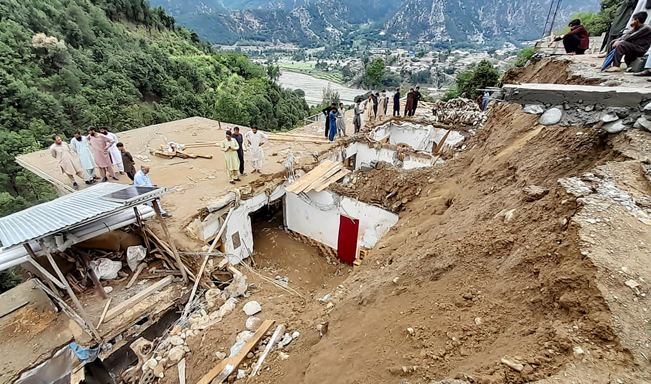 In this file photo, taken on August 30, 2024, residents gather at the site of a landslide owing to heavy monsoon rains in the remote area of Patrak, in Upper Dir district, Khyber Pakhtunkhwa province. (AFP/File)